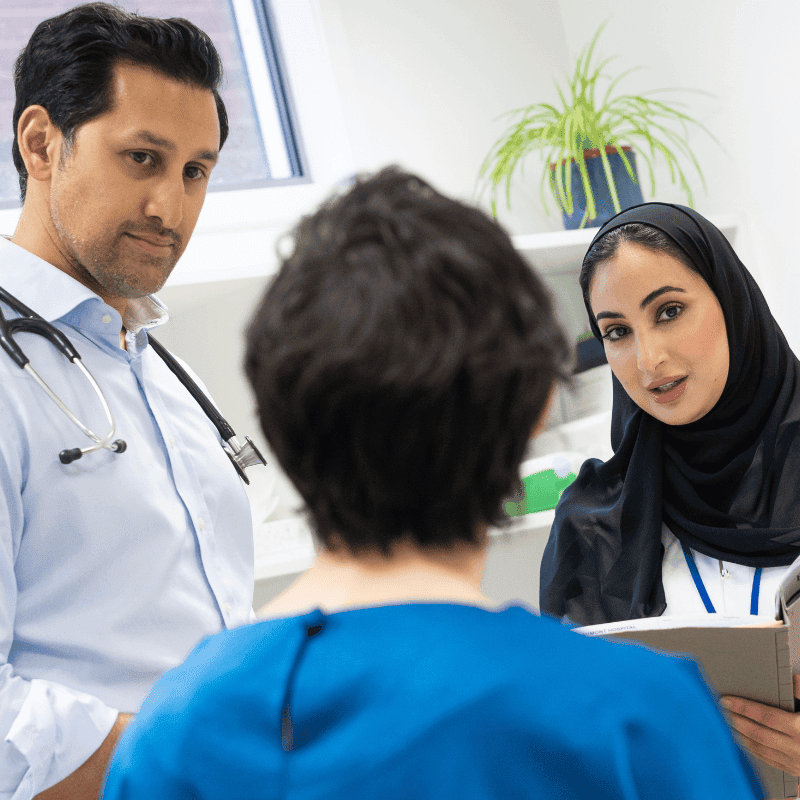 Doctors consulting patient in clinical setting
